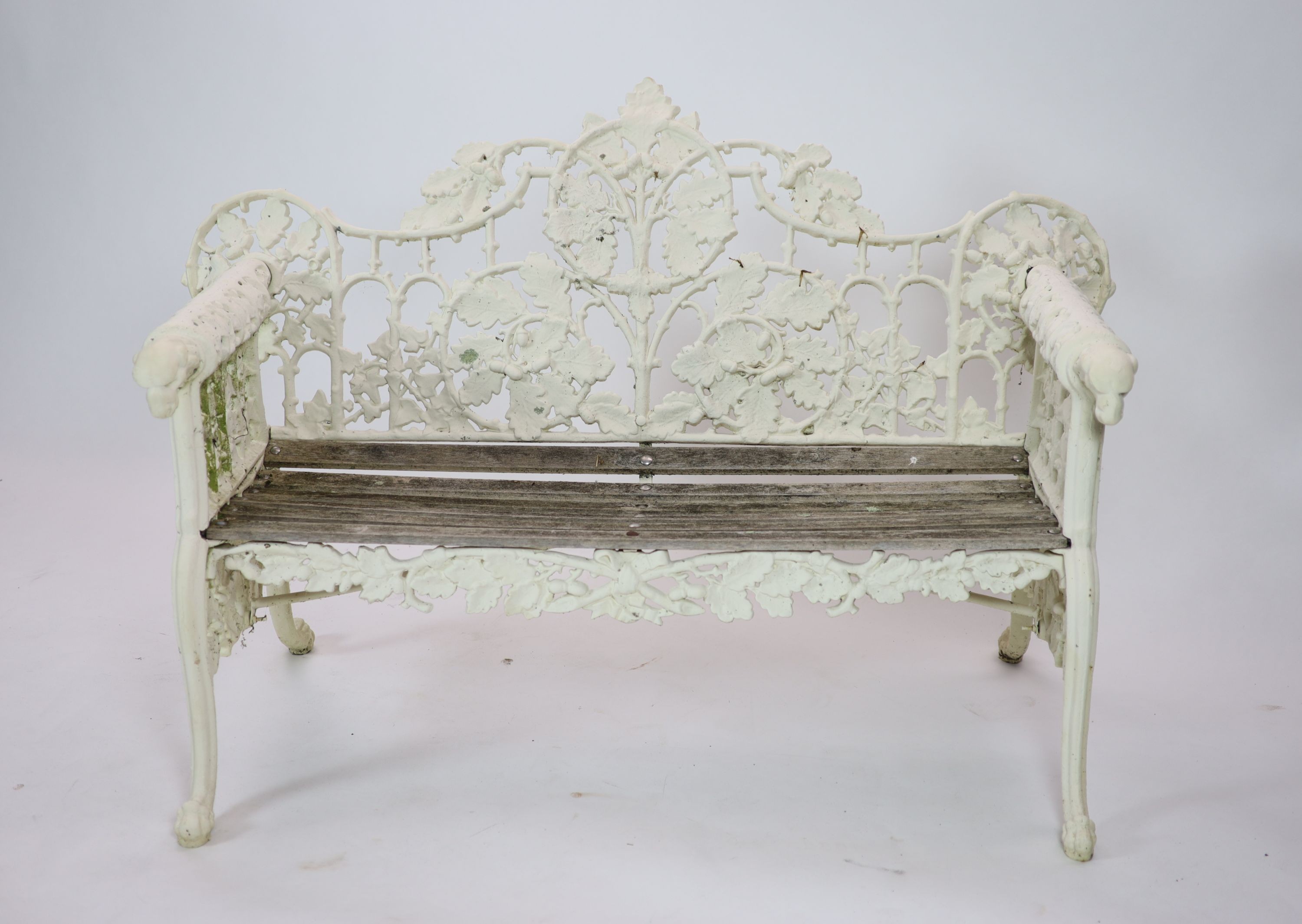 After Coalbrookdale, a pair of cast iron ‘Oak and ivy' benches H 95cm. W 148cm. D 68cm.